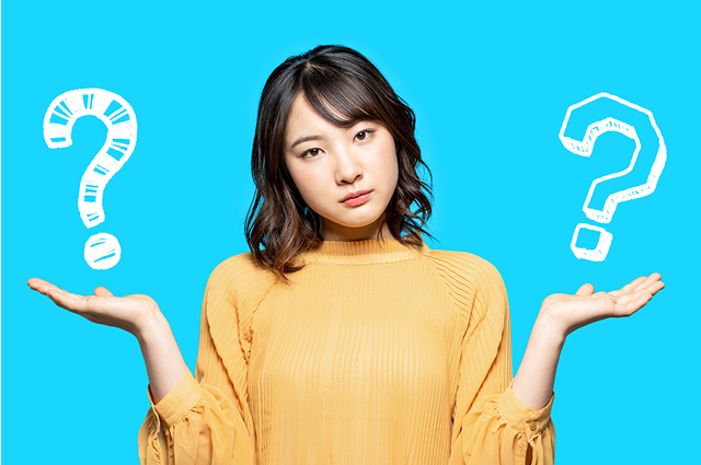 A woman in a yellow top stands against a blue background, holding her hands up with illustrated question marks above each hand, looking confused or uncertain.