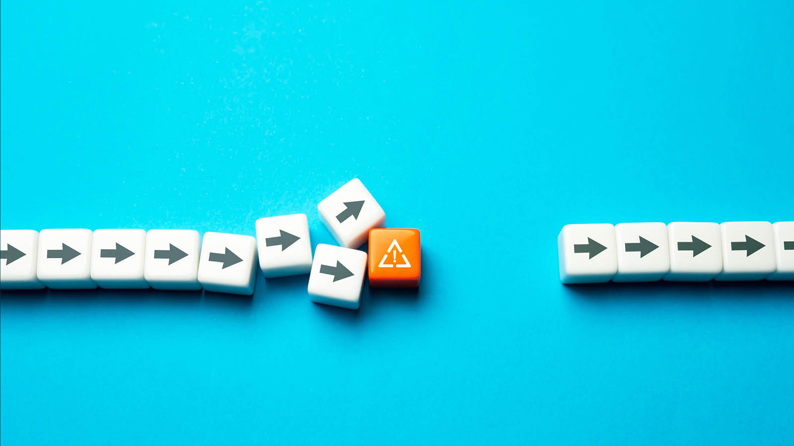 a line of white blocks with arrows pointing to the right being disrupted by an orange block with a caution symbol representing a bottleneck in the mortgage process