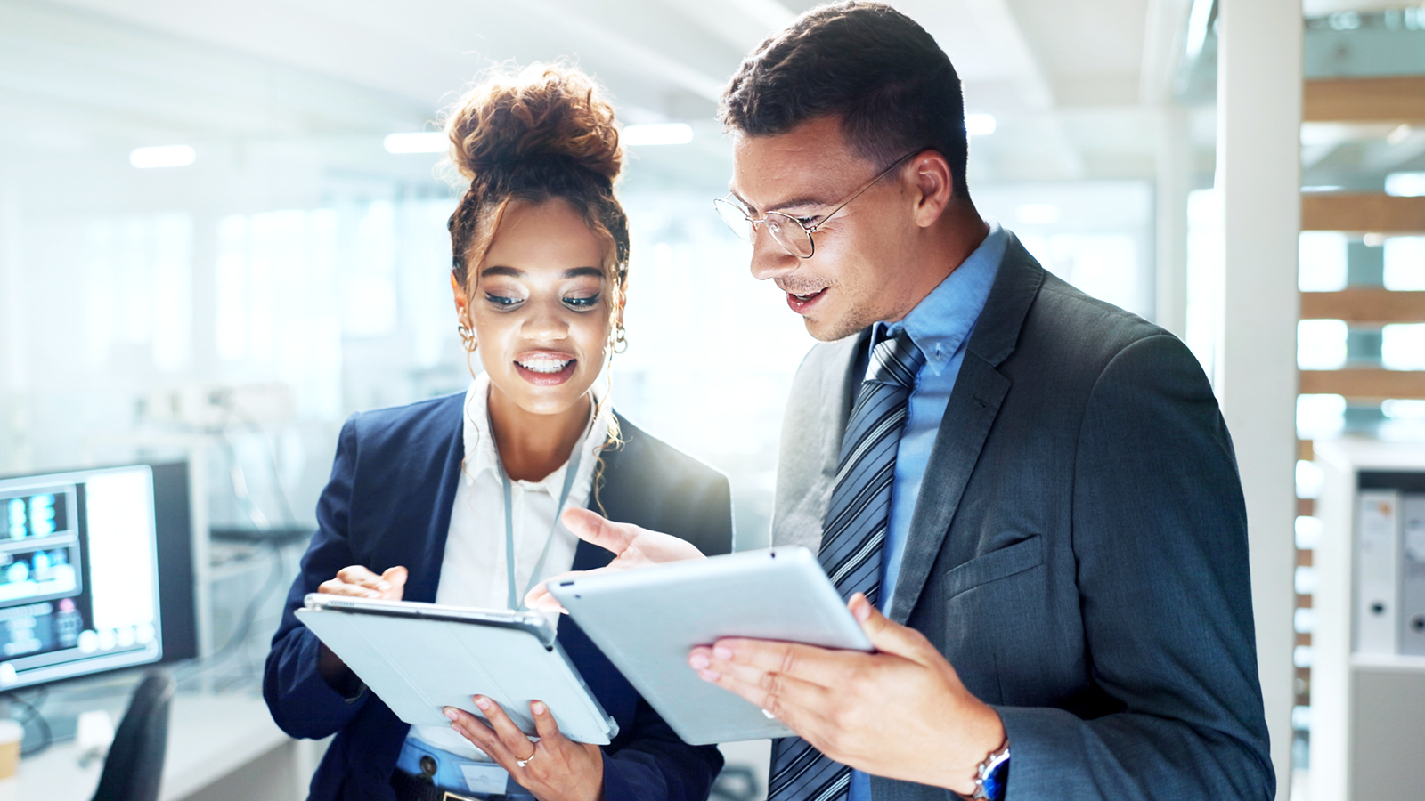 Man and woman business professionals working together on iPad